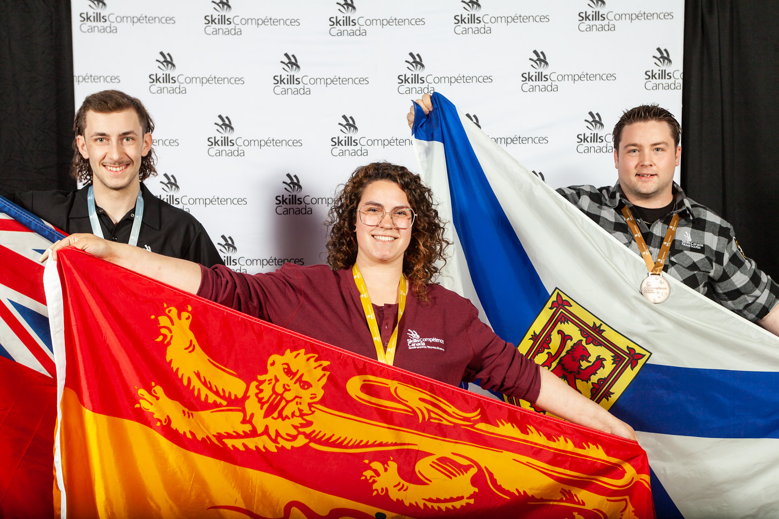 NBCC apprentice Alice Michaud, centre, won gold in the Car Painting competition at Skills Canada nationals. Michaud also won Best in Region for New Brunswick. 